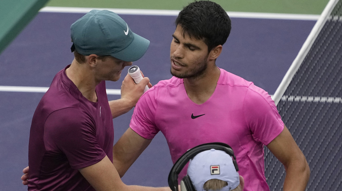 Jannik Sinner, of Italy, left, talks with Carlos Alcaraz, of Spain, after Alcarz defeated Sinner.